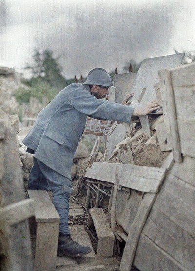 A French soldier in the Army lookout 26 viewing the area in front of him through a protective metal shield, Eglingen, Department Haut-Rhin, Alsace, France, June 26, 1917 by Paul Castelnau